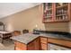 Basement wet bar with granite countertop, beverage fridge, and glass display at 1758 E Carver Rd, Tempe, AZ 85284