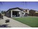 Well-maintained backyard with artificial grass, showcasing the covered patio and outdoor amenities at 1972 N Hubbard Ln, Casa Grande, AZ 85122