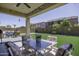 A charming backyard featuring well-manicured artificial grass, covered patio and outdoor furniture at 1972 N Hubbard Ln, Casa Grande, AZ 85122