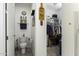 Bathroom featuring neutral colors, toilet with grab bars, and a doorway leading into a walk-in closet at 1972 N Hubbard Ln, Casa Grande, AZ 85122