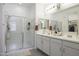 Bright bathroom features dual sinks, quartz countertops, and a glass shower at 1972 N Hubbard Ln, Casa Grande, AZ 85122