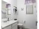 Clean bathroom featuring a sink vanity, toilet, and shower with a lavender shower curtain at 1972 N Hubbard Ln, Casa Grande, AZ 85122