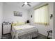 Bright bedroom with plush carpet, ceiling fan, and soft yellow bedding at 1972 N Hubbard Ln, Casa Grande, AZ 85122