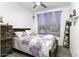 Cozy bedroom with carpet flooring, ceiling fan, and beautiful decor, including purple floral bedding at 1972 N Hubbard Ln, Casa Grande, AZ 85122