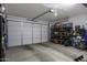 Well-lit garage with white door and ample storage shelving and electric bike at 1972 N Hubbard Ln, Casa Grande, AZ 85122