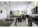 Open-concept kitchen featuring granite countertops, stainless appliances, and adjacent dining area with backyard views at 1972 N Hubbard Ln, Casa Grande, AZ 85122