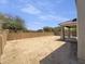 Large, unfinished backyard features a covered patio and block wall for privacy at 21262 E Cherrywood Dr, Queen Creek, AZ 85142
