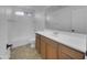 Well-lit bathroom with a single sink, wood cabinets, toilet and shower-tub combo at 21262 E Cherrywood Dr, Queen Creek, AZ 85142