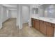 Bright bathroom with dual sinks, tile floor, and large mirror with a view to the main bedroom at 21262 E Cherrywood Dr, Queen Creek, AZ 85142