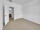 Empty bedroom featuring carpet, neutral paint, and an open door view to the attached bathroom at 21262 E Cherrywood Dr, Queen Creek, AZ 85142