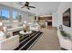Bright living room with contemporary furnishings, open floor plan, and seamless flow to the kitchen and backyard at 21262 E Cherrywood Dr, Queen Creek, AZ 85142