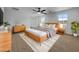 Well-lit main bedroom featuring modern decor, ample space, and access to the ensuite bathroom at 21262 E Cherrywood Dr, Queen Creek, AZ 85142