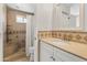 Neutral bathroom featuring a walk-in shower with tile surround, a vanity, and a framed mirror at 2745 E Dahlia Dr, Phoenix, AZ 85032