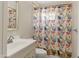 Bright bathroom featuring a vanity and a bathtub with a colorful, patterned shower curtain at 2745 E Dahlia Dr, Phoenix, AZ 85032