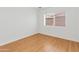 Simple bedroom featuring wood-look floors and a window, providing a clean, minimalist space at 2745 E Dahlia Dr, Phoenix, AZ 85032