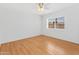 Cozy bedroom featuring wood-look floors, ceiling fan and a window with natural light at 2745 E Dahlia Dr, Phoenix, AZ 85032