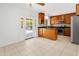 Cozy kitchen with wood cabinets, stainless steel appliances, and access to backyard patio at 2745 E Dahlia Dr, Phoenix, AZ 85032