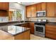 Gorgeous kitchen featuring wood cabinets, granite countertops, stainless appliances, and a window at 2745 E Dahlia Dr, Phoenix, AZ 85032