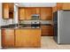 Well-lit kitchen with stainless steel appliances, granite countertops, and wood cabinets at 2745 E Dahlia Dr, Phoenix, AZ 85032