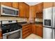 Traditional kitchen featuring stainless steel appliances, wood cabinetry, and dark granite countertops at 2745 E Dahlia Dr, Phoenix, AZ 85032
