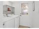 Functional laundry area equipped with white washer, dryer, door to outside, and shelving at 2745 E Dahlia Dr, Phoenix, AZ 85032