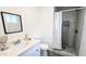 Stylish bathroom with a modern vanity, sleek mirror, and tiled shower, providing a luxurious experience at 3128 E Desert Cove Ave, Phoenix, AZ 85028