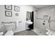 Accessible bathroom featuring grab bars, a sleek sink, and tiled shower, prioritizing safety and style at 3128 E Desert Cove Ave, Phoenix, AZ 85028