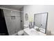 Updated bathroom with a modern vanity, elegant mirror, and tiled walk-in shower at 3128 E Desert Cove Ave, Phoenix, AZ 85028