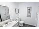 Clean bathroom with white vanity, modern fixtures, and decorative mirror at 3128 E Desert Cove Ave, Phoenix, AZ 85028