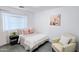 Bright bedroom with a cozy chair, decorative pillows, and natural light, creating a serene atmosphere at 3128 E Desert Cove Ave, Phoenix, AZ 85028