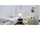 Bright bedroom with white walls, modern decor, and comfortable seating, offering a clean and stylish space at 3128 E Desert Cove Ave, Phoenix, AZ 85028