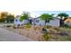Charming home with a well-manicured front yard with desert landscaping and mature trees at 3128 E Desert Cove Ave, Phoenix, AZ 85028