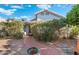 Landscaped backyard with brick pathway and lush greenery with a peek of the home at 3550 E Edna Ave, Phoenix, AZ 85032