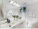 Bright bathroom with double sinks, large mirror, blue shelves, and tile flooring at 3550 E Edna Ave, Phoenix, AZ 85032