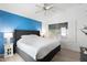 Bright bedroom featuring a large bed with grey headboard and a calming blue accent wall at 3550 E Edna Ave, Phoenix, AZ 85032
