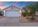 Charming single story home showcasing a two car garage, mature landscaping and a cozy desert front yard at 3550 E Edna Ave, Phoenix, AZ 85032