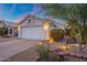 Charming home exterior showcases a two-car garage, landscaped yard, and inviting walkway at 3550 E Edna Ave, Phoenix, AZ 85032