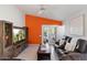 Cozy living room with a decorative accent wall, plantation shutters, and comfortable leather seating at 3550 E Edna Ave, Phoenix, AZ 85032