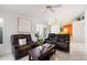 Bright living room featuring neutral walls, tile flooring, plantation shutters, and comfortable leather seating at 3550 E Edna Ave, Phoenix, AZ 85032