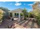 Covered patio with seating area, fire pit, and brick flooring surrounded by lush landscaping at 3550 E Edna Ave, Phoenix, AZ 85032