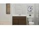 Bright bathroom featuring a stylish vanity, modern art, and a partial view of a glass shower at 3703 E Gold Mountain Ave, San Tan Valley, AZ 85143