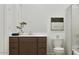 Modern bathroom with a sleek vanity, decorative art, and a shower with stylish curtain at 3703 E Gold Mountain Ave, San Tan Valley, AZ 85143