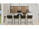 Contemporary kitchen featuring a breakfast bar with seating, stylish lighting, and modern appliances at 3703 E Gold Mountain Ave, San Tan Valley, AZ 85143