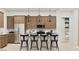 Bright kitchen with a center island, bar stool seating, and stainless steel appliances at 3703 E Gold Mountain Ave, San Tan Valley, AZ 85143