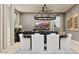 Stylishly furnished living room with a dining area, modern lighting, and neutral decor at 3703 E Gold Mountain Ave, San Tan Valley, AZ 85143