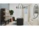 Home office featuring a modern desk, stylish storage, and comfortable seating under a sleek chandelier at 3703 E Gold Mountain Ave, San Tan Valley, AZ 85143