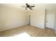 Spacious bedroom with neutral walls, ceiling fan and wood-look flooring at 38133 W Vera Cruz Dr, Maricopa, AZ 85138