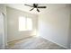 Bedroom with lots of natural light, wood-look flooring, and a ceiling fan at 38133 W Vera Cruz Dr, Maricopa, AZ 85138