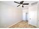 Bright bedroom with wood-look floors, ceiling fan, closet, and neutral walls, creating a relaxing atmosphere at 38133 W Vera Cruz Dr, Maricopa, AZ 85138