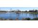 Scenic lake view with a gazebo and surrounding homes, showcasing the tranquil community atmosphere at 38133 W Vera Cruz Dr, Maricopa, AZ 85138